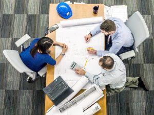 three people having an office meeting